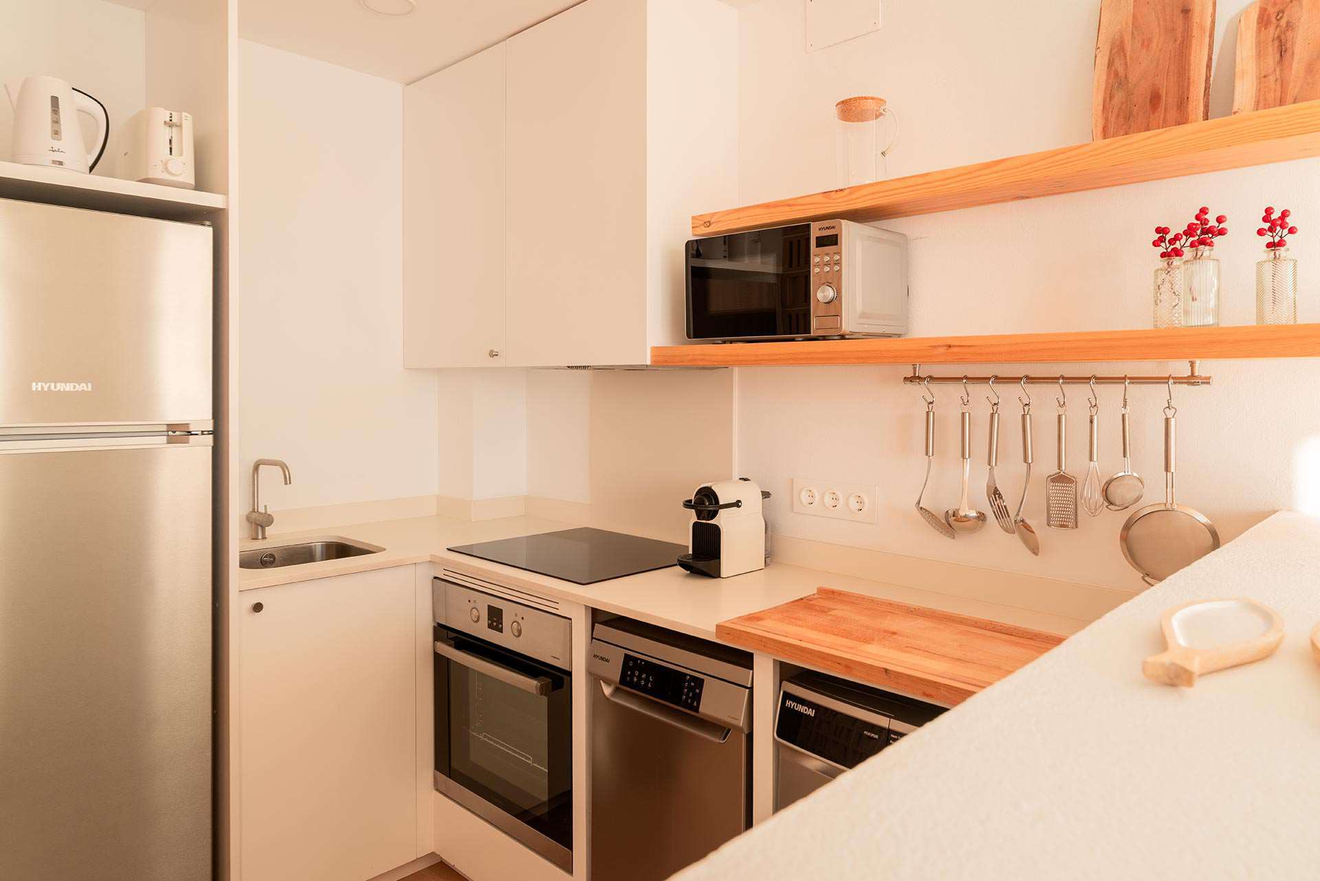Cuina equipada de S'Arenella amb forn, microones i prestatges de fusta